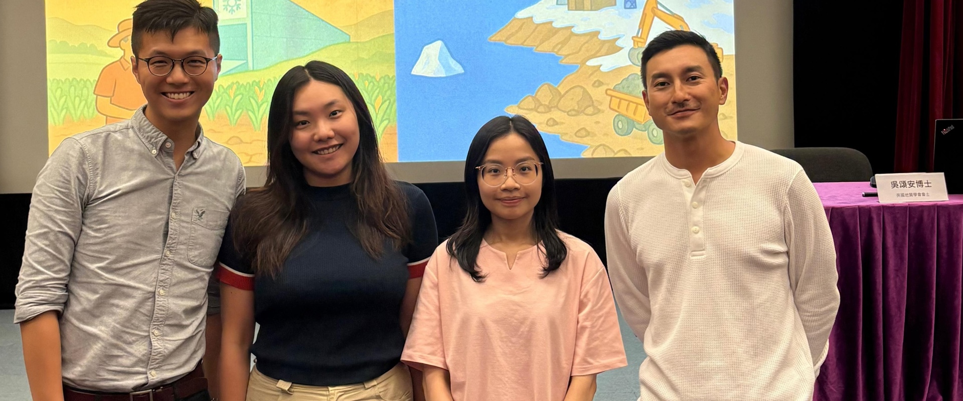 two males and two females smiling