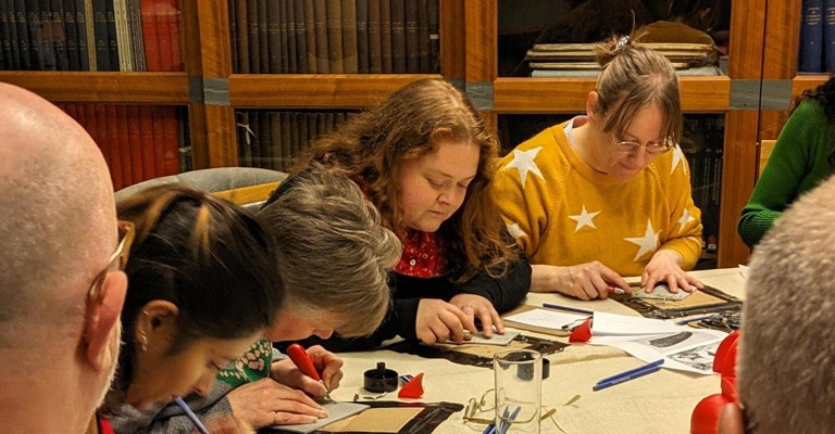 People doing dinosaur linocut printing