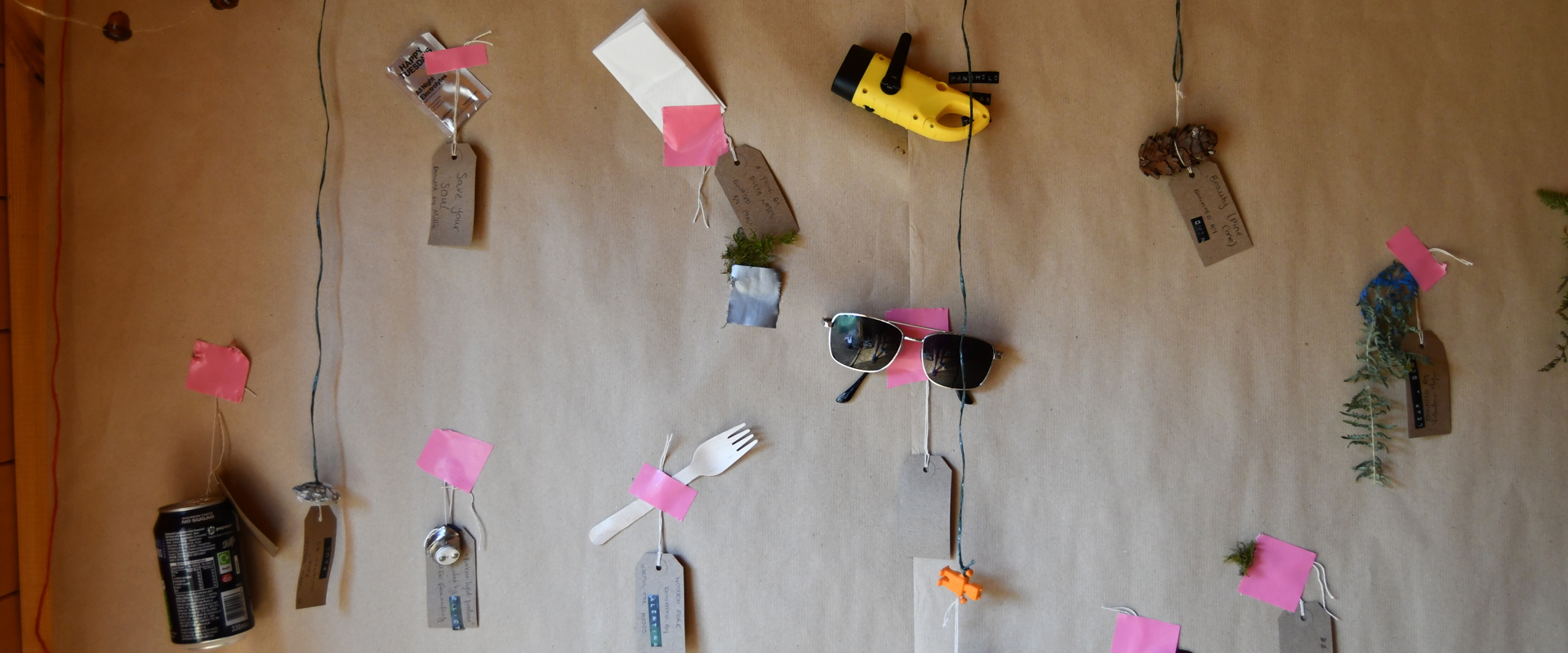 Items hanging a wall with labels simulating a museum exhibition