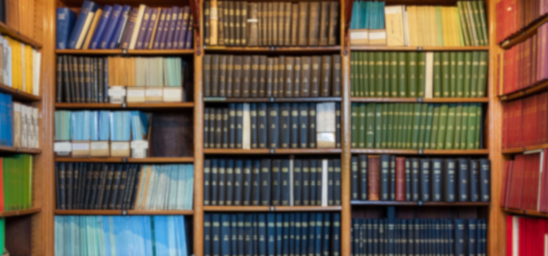 Books of different colours on shelves