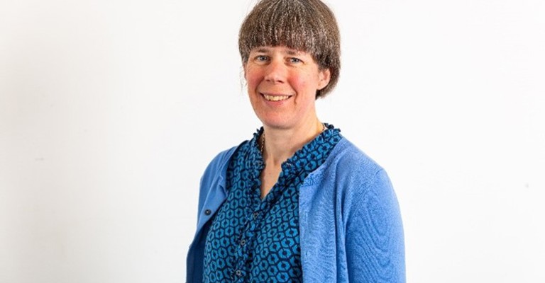 woman wearing a blue blouse and cardigan