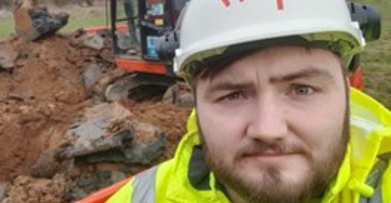 white man in hard and and high vis jacket