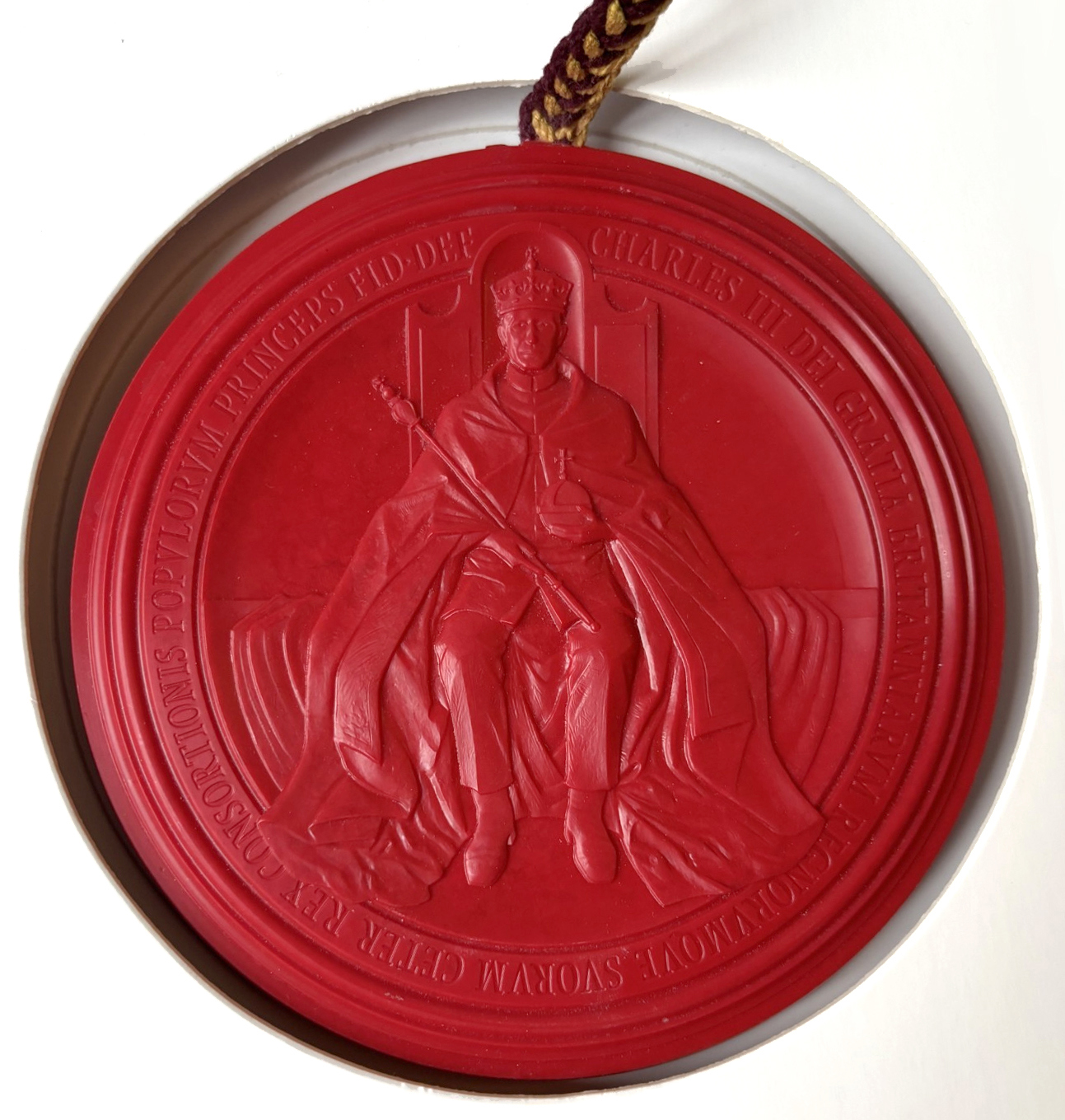 A circular, red seal with King Charles III for the Geological Society's Supplemental Charter