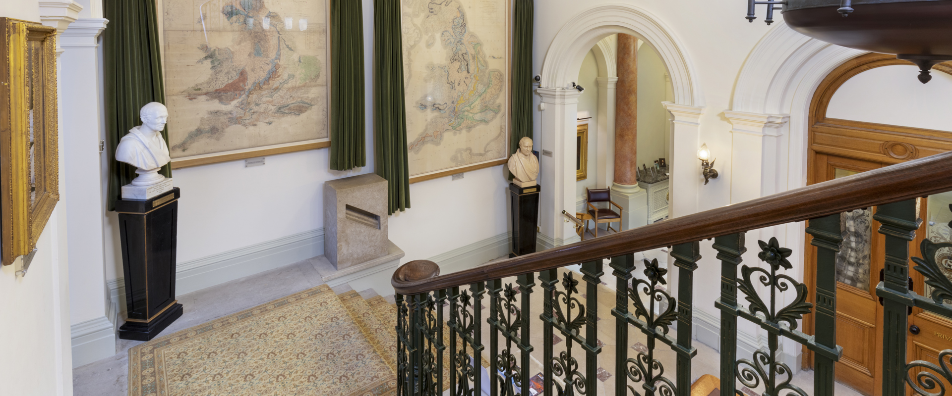 Large Hallway with grand staircase and a map of the UK 
